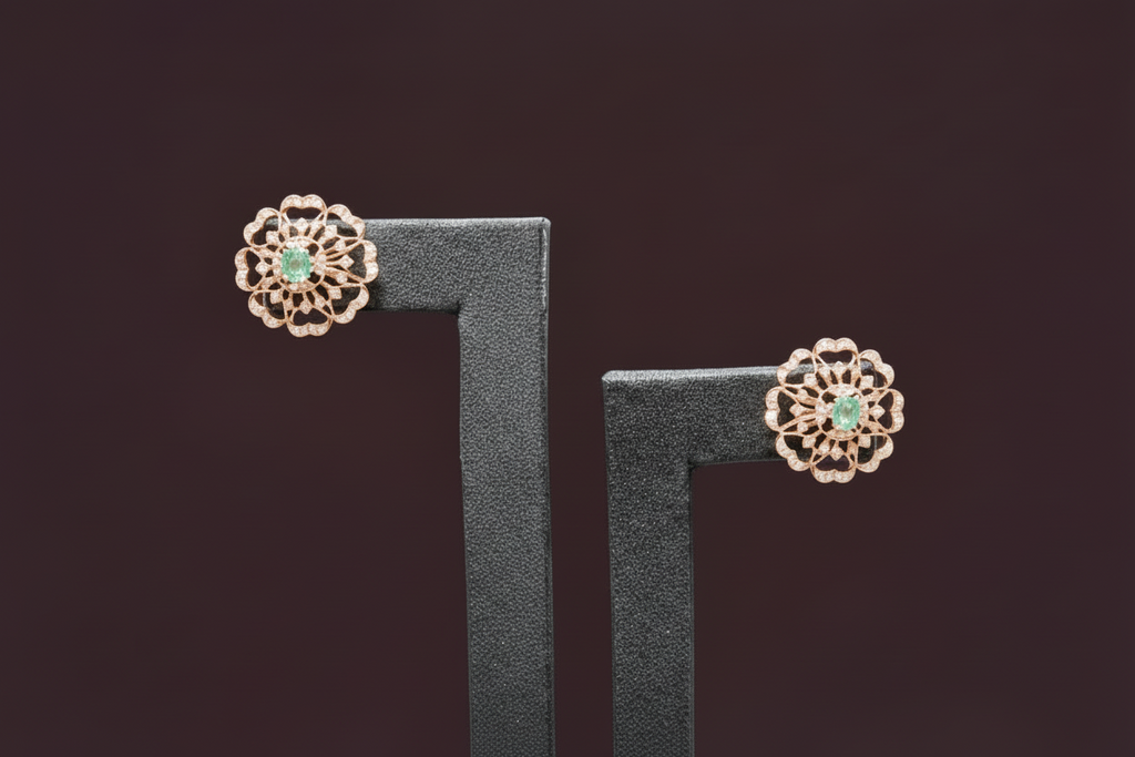 18kt Gold and Diamond earrings with gemstones on a gray stand against a neutral background